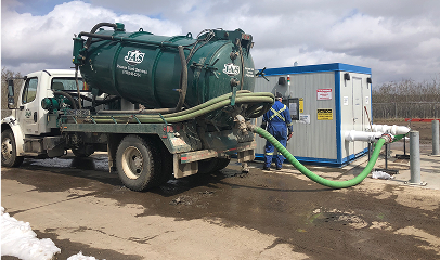Man unloading septage tank at a septage receiving station.
